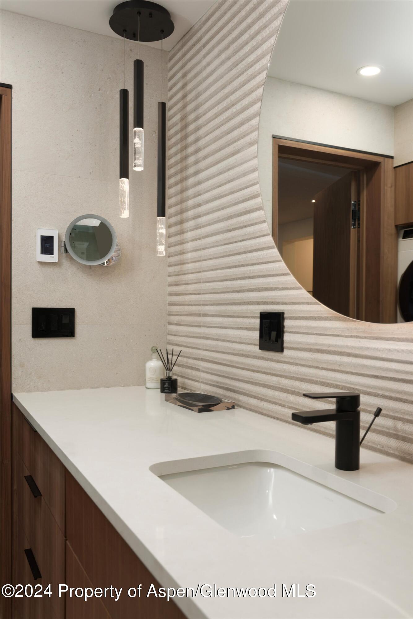 205 East Durant Avenue, Unit 1I Aspen, CO 81611 - Photo 28 of 45 a bathroom with a sink and a mirror