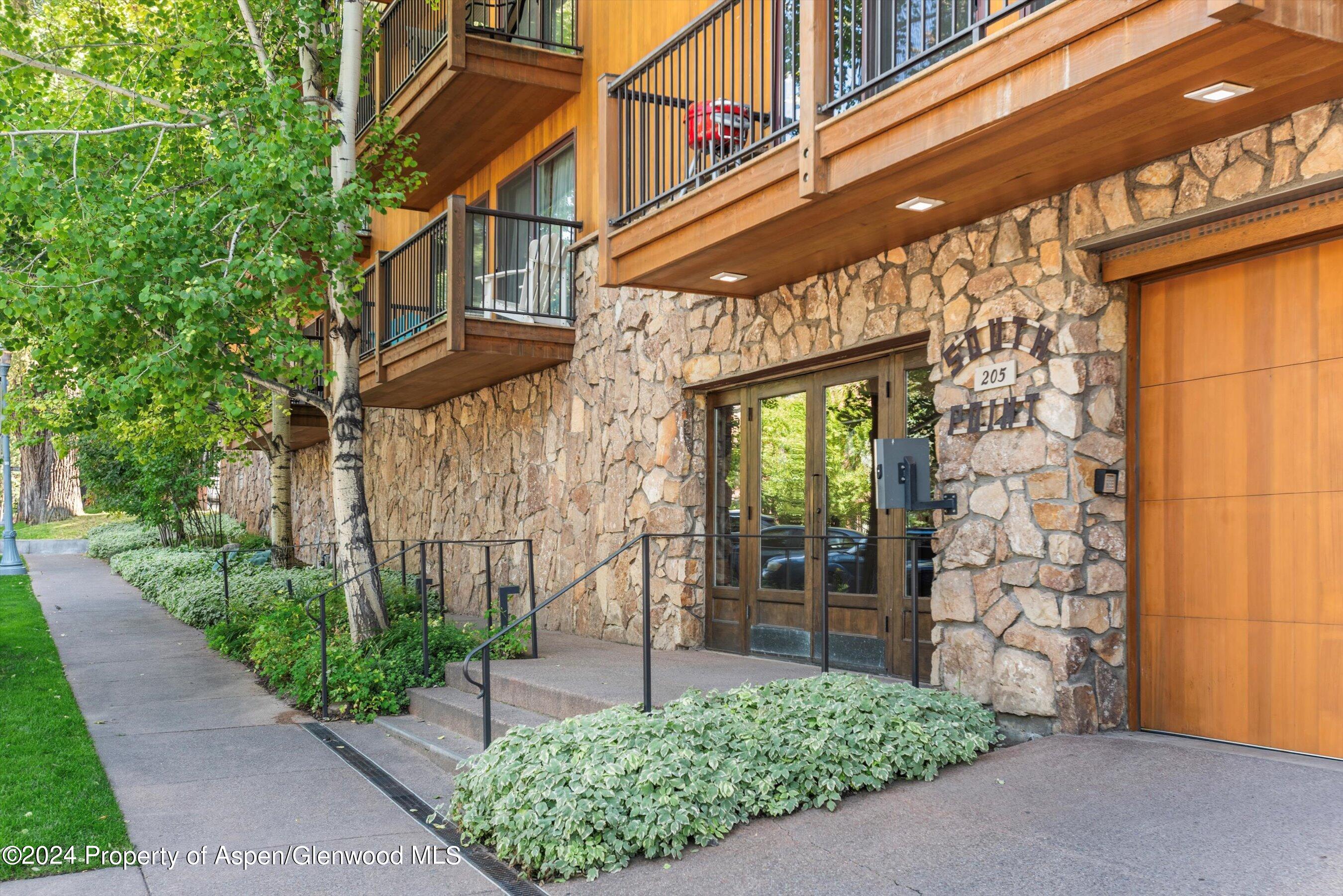 205 East Durant Avenue, Unit 1I Aspen, CO 81611 - Photo 32 of 45 a view of a building with a garden