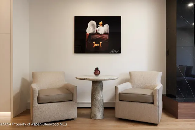 a living room with furniture and wall paintings