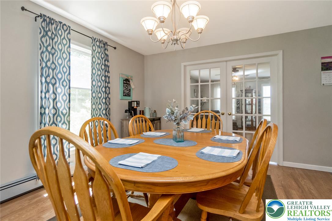 9461 Red Road Kempton, PA 19529 - Photo 14 of 55 An inviting dining room with warm wood flooring features French doors that open to additional living space.
