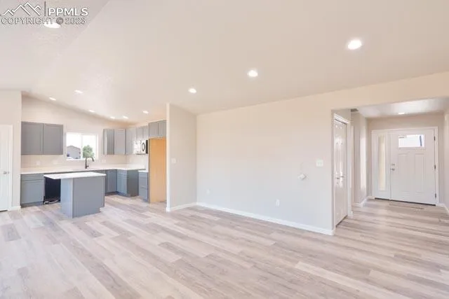 a open kitchen with stainless steel appliances kitchen island a refrigerator sink and cabinets
