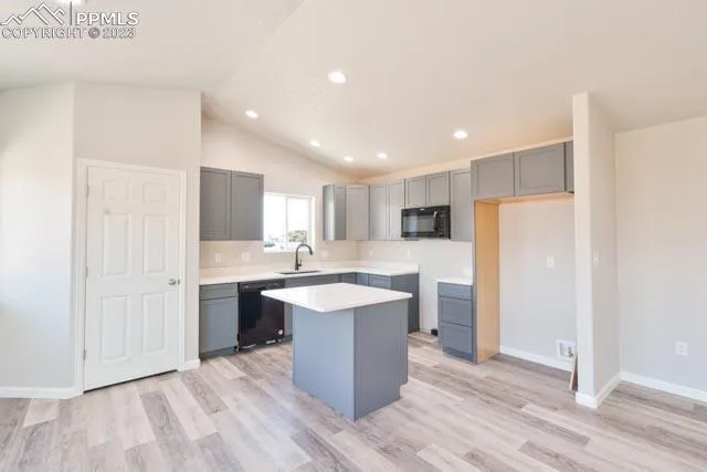 a kitchen with a sink stainless steel appliances and white cabinets