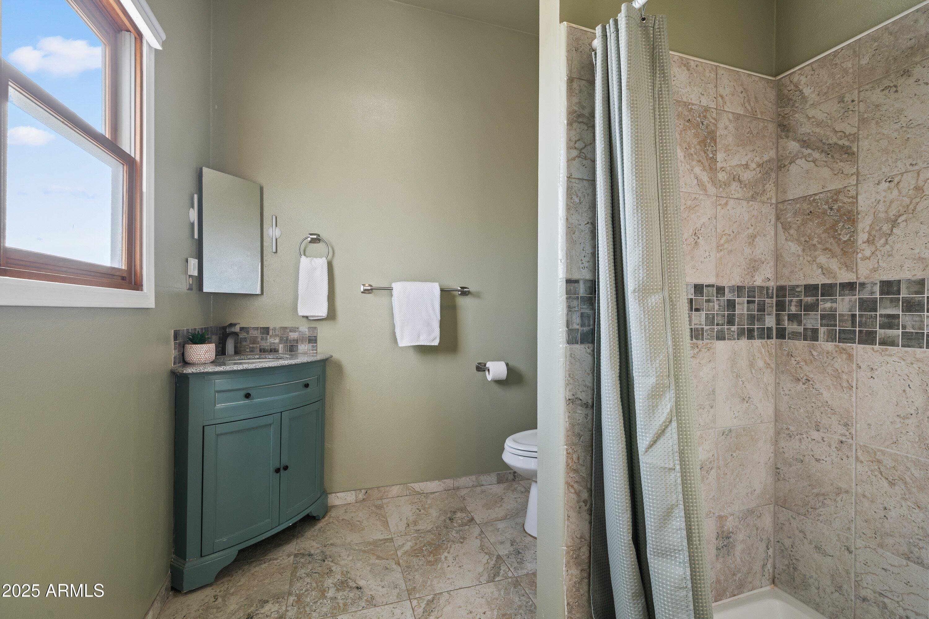 105 Los Encinos Road Sonoita, AZ 85637 - Photo 17 of 39 a bathroom with a granite countertop sink toilet and shower