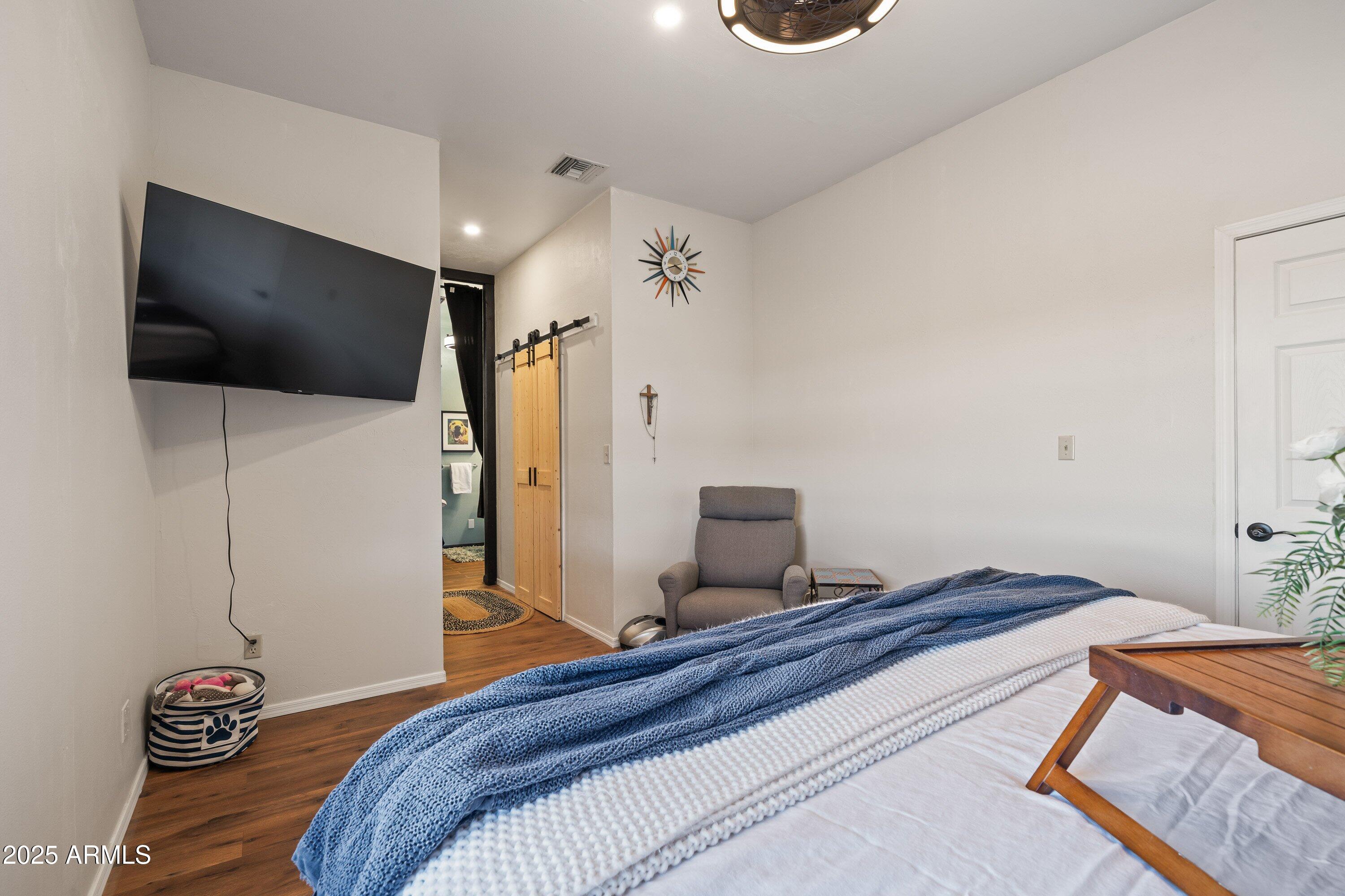 105 Los Encinos Road Sonoita, AZ 85637 - Photo 20 of 39 a bedroom with a bed and a flat screen tv