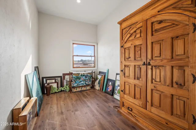 a view of a patio with a table chairs and wooden floor