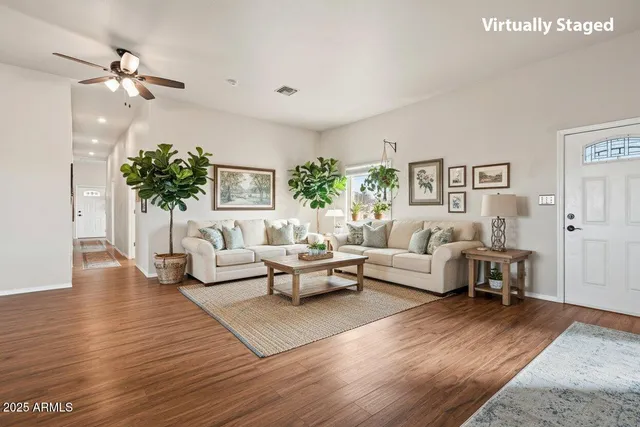 a living room with furniture and a chandelier