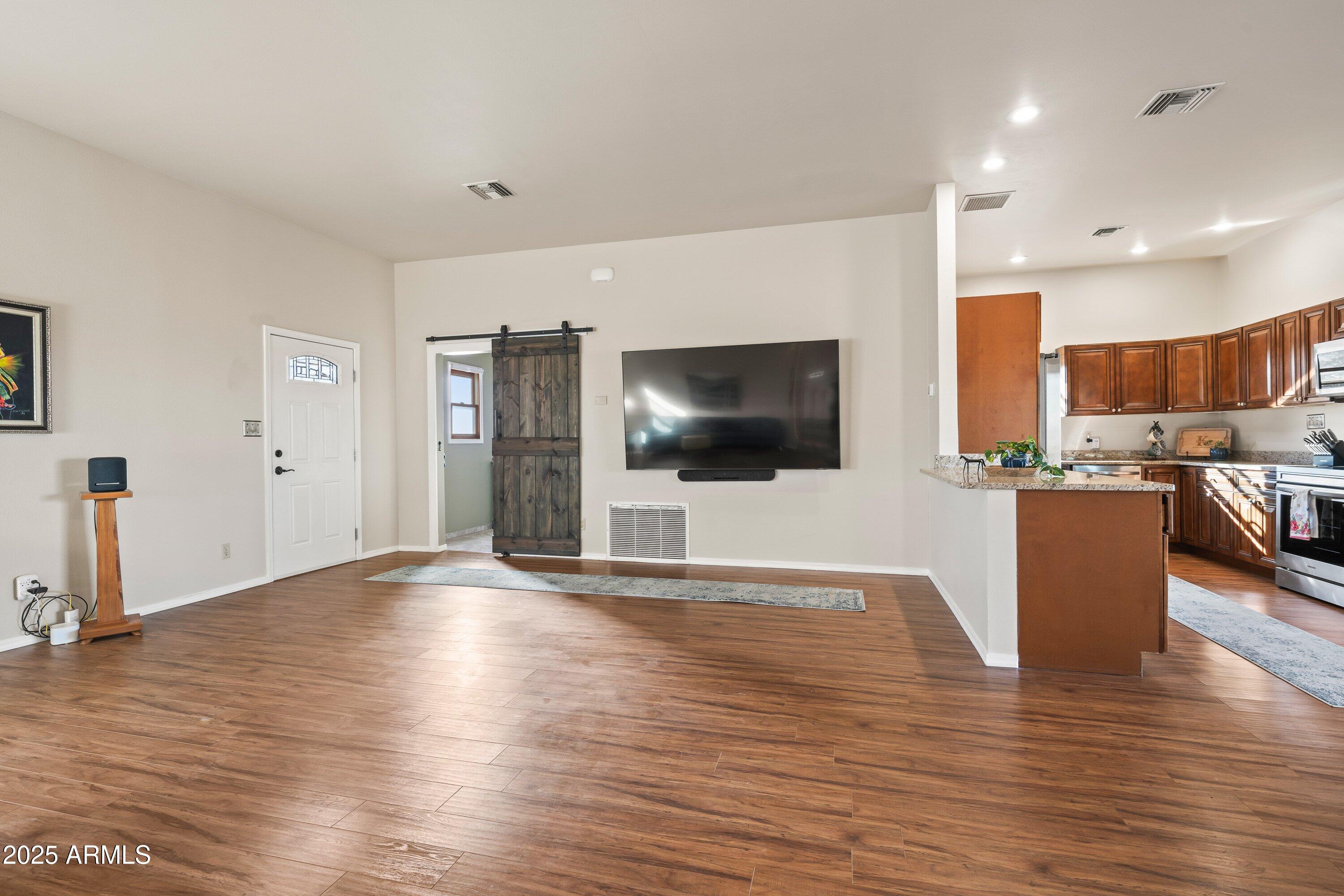 105 Los Encinos Road Sonoita, AZ 85637 - Photo 5 of 39 a view of a living room a flat screen tv and kitchen view