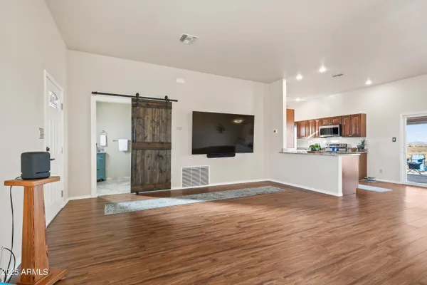a view of a kitchen with wooden floor and a sink