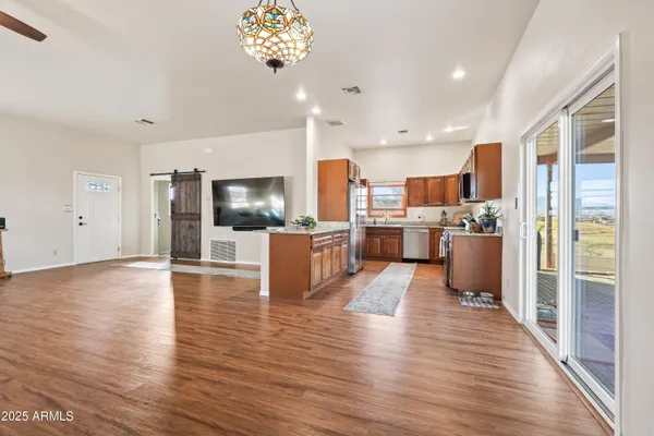 a view of kitchen with kitchen island and stainless steel appliances