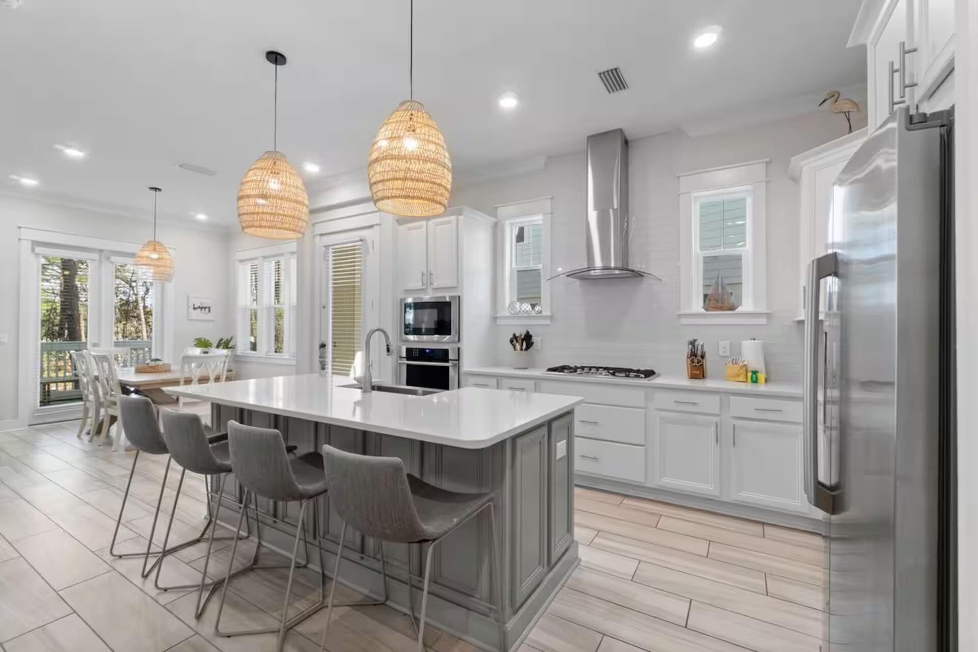 146 East E Pine, Unit B Inlet Beach, FL 32461 - Photo 10 of 47 a kitchen with stainless steel appliances granite countertop a sink a stove a refrigerator cabinets and chairs