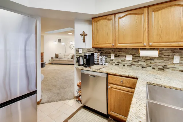 a kitchen with stainless steel appliances granite countertop a sink stove and cabinets