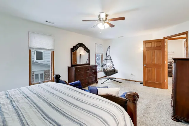 a bedroom with bed and a chandelier