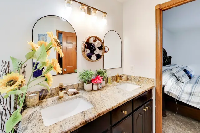 a bathroom with a granite countertop sink a mirror and vanity