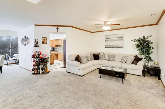 a living room with furniture and a chandelier