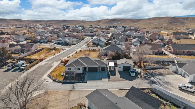 an aerial view of a house with a mountain