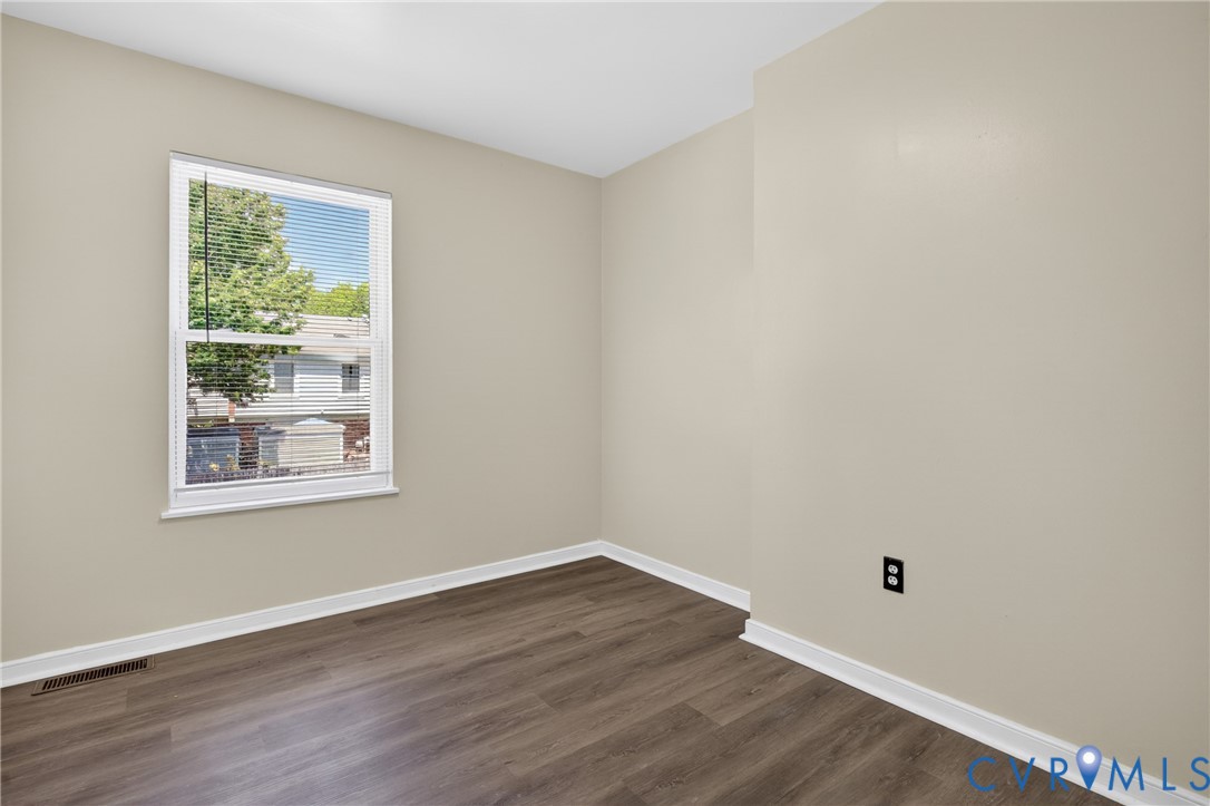 10050 Purcell Road Richmond, VA 23228 - Photo 18 of 26 a view of an empty room with wooden floor and a window
