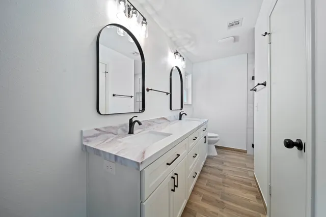 a bathroom with a double vanity sink and mirror