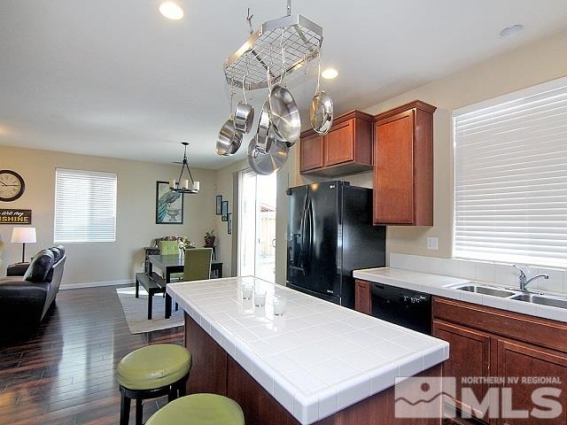 11615 Verazae Drive Reno, NV 89521 - Photo 12 of 25 a kitchen with a table chairs stove and refrigerator