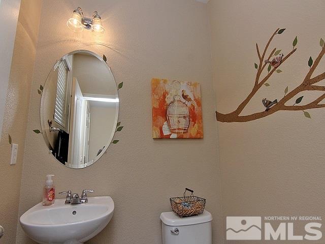 11615 Verazae Drive Reno, NV 89521 - Photo 17 of 25 a bathroom with a toilet sink and mirror