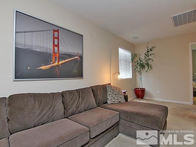 11615 Verazae Drive Reno, NV 89521 - Photo 7 of 25 a living room with a couch and a potted plant