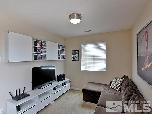 11615 Verazae Drive Reno, NV 89521 - Photo 8 of 25 a living room with furniture and a flat screen tv