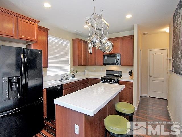 11615 Verazae Drive Reno, NV 89521 - Photo 9 of 25 a kitchen with a sink a stove and refrigerator