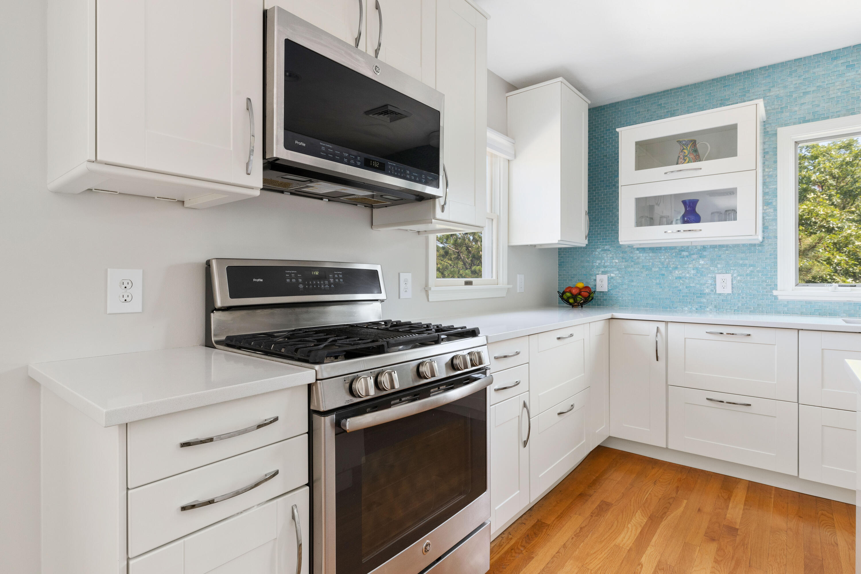 5 Starbuck Road Truro, MA 02666 - Photo 15 of 46 a kitchen with stainless steel appliances white cabinets granite counter tops and a wooden floors