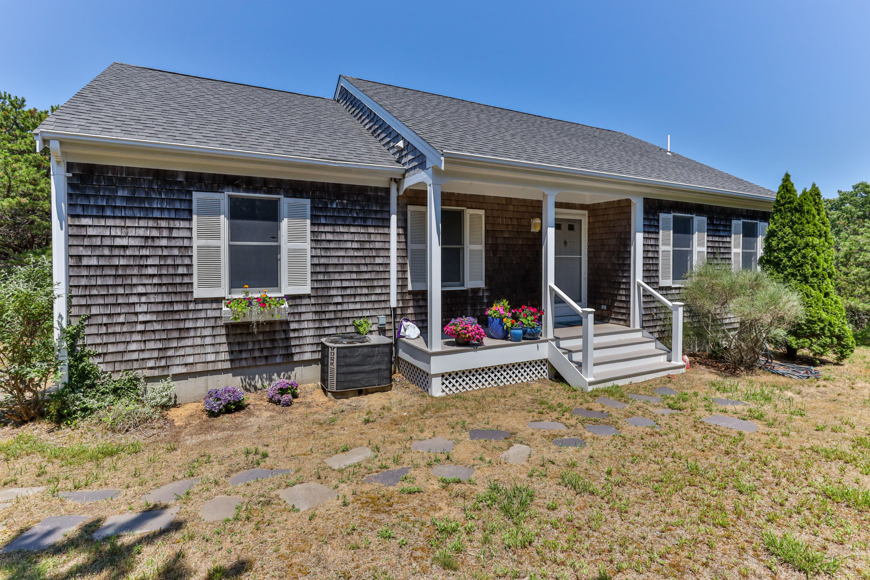5 Starbuck Road Truro, MA 02666 - Photo 2 of 46 a view of a house that has a small yard and large tree