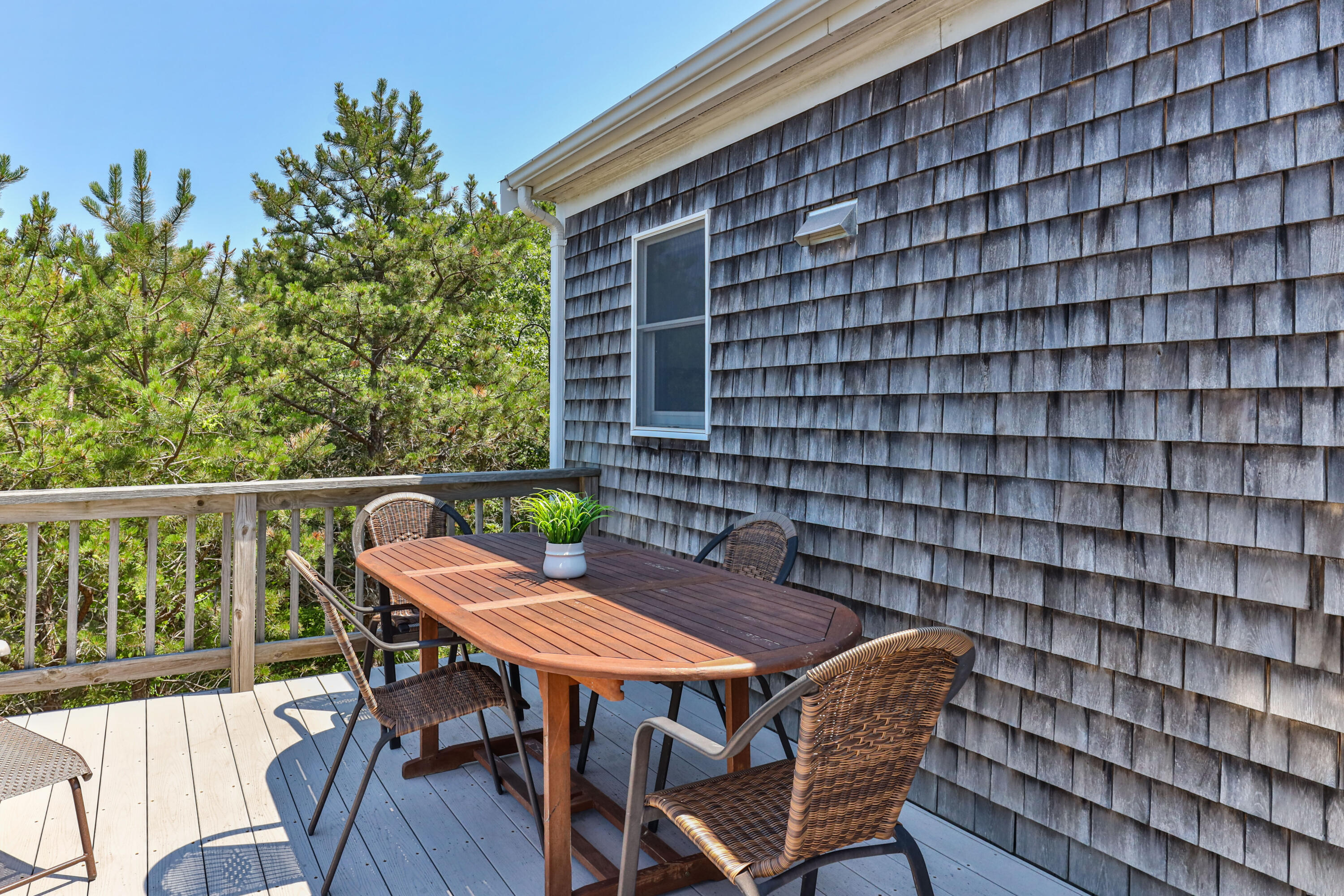 5 Starbuck Road Truro, MA 02666 - Photo 40 of 46 a roof deck with a dining table and chair with wooden floor