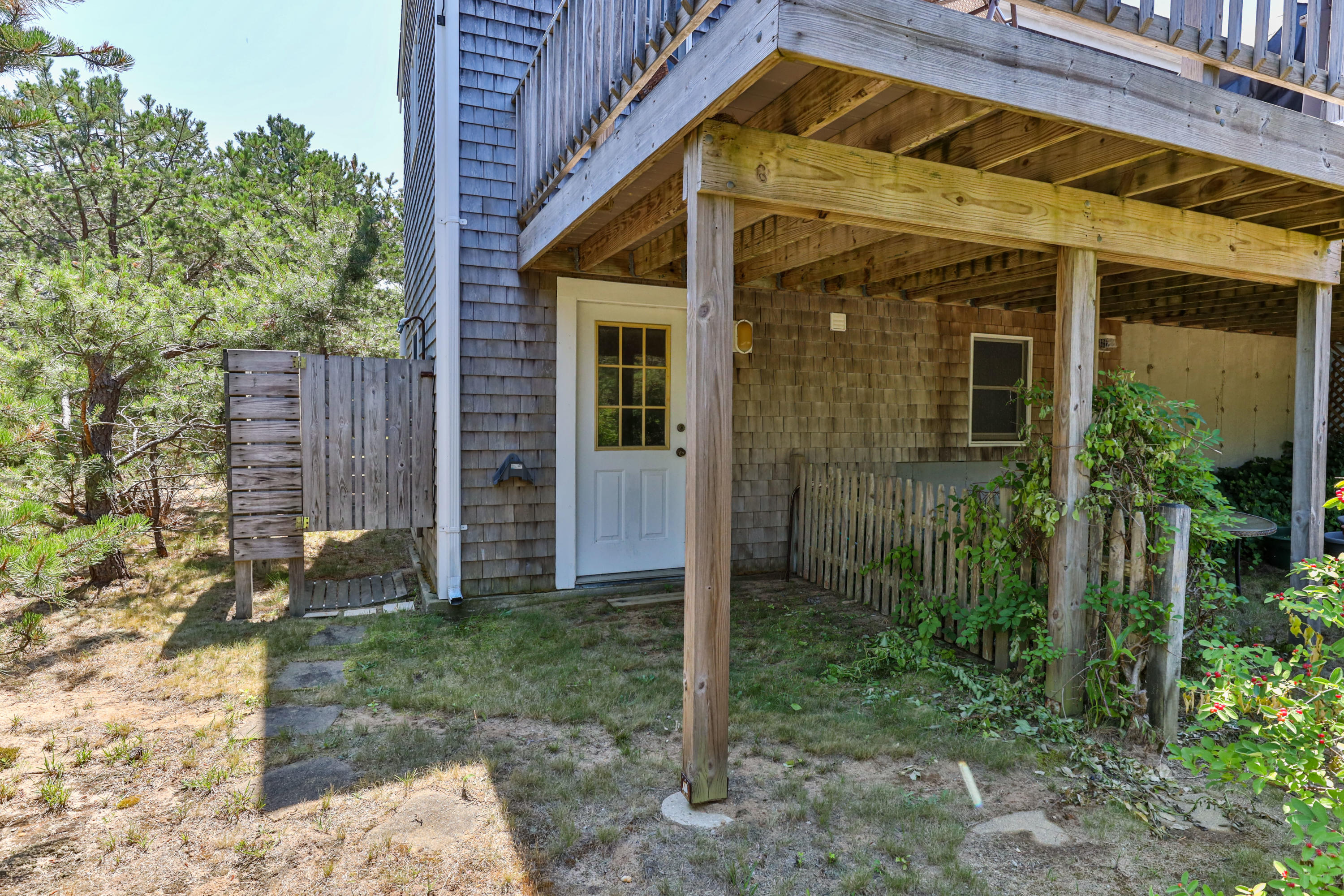 5 Starbuck Road Truro, MA 02666 - Photo 45 of 46 a view of a small house with a small yard and plants
