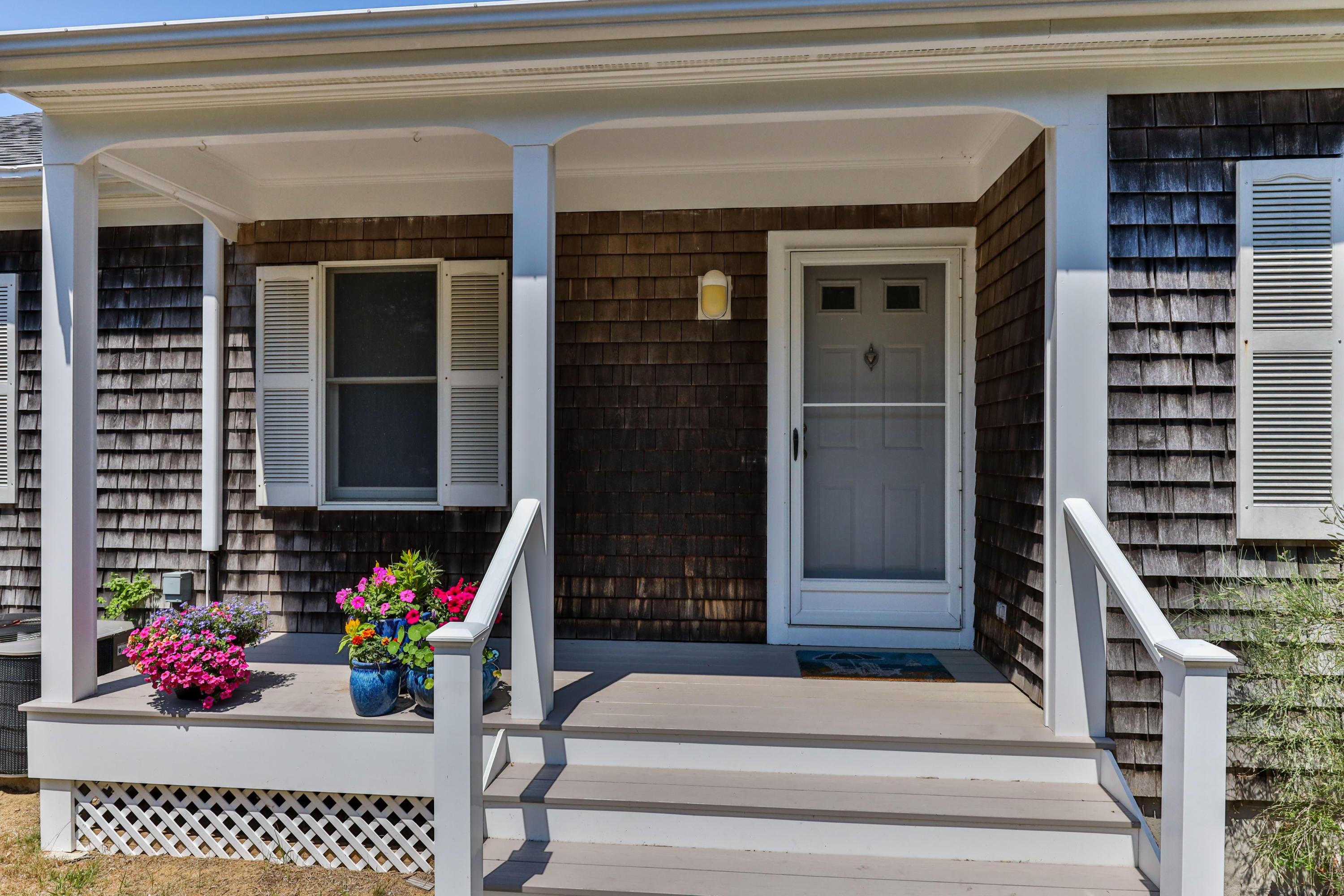 5 Starbuck Road Truro, MA 02666 - Photo 6 of 46 a front view of a house with a potted plant