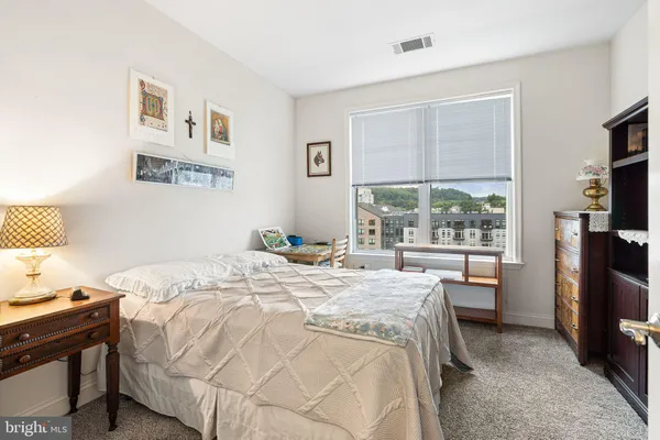 a bedroom with a bed and a large window