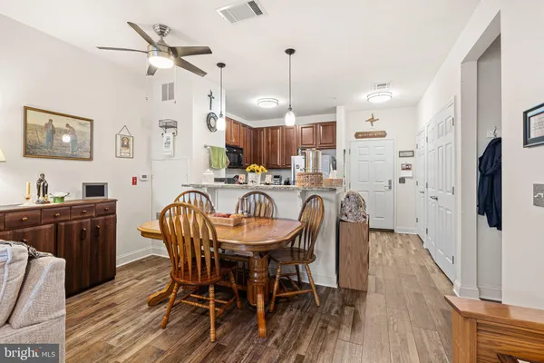 a view of a dining room with furniture and wooden floor