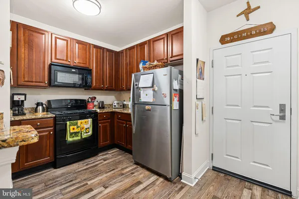a kitchen with stainless steel appliances granite countertop a refrigerator stove and sink