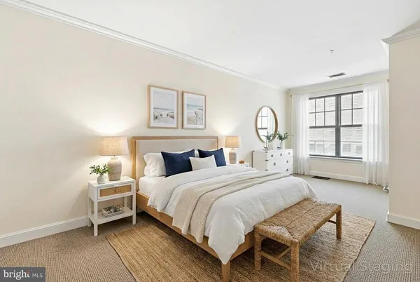 a bedroom with a bed a chandelier and a window