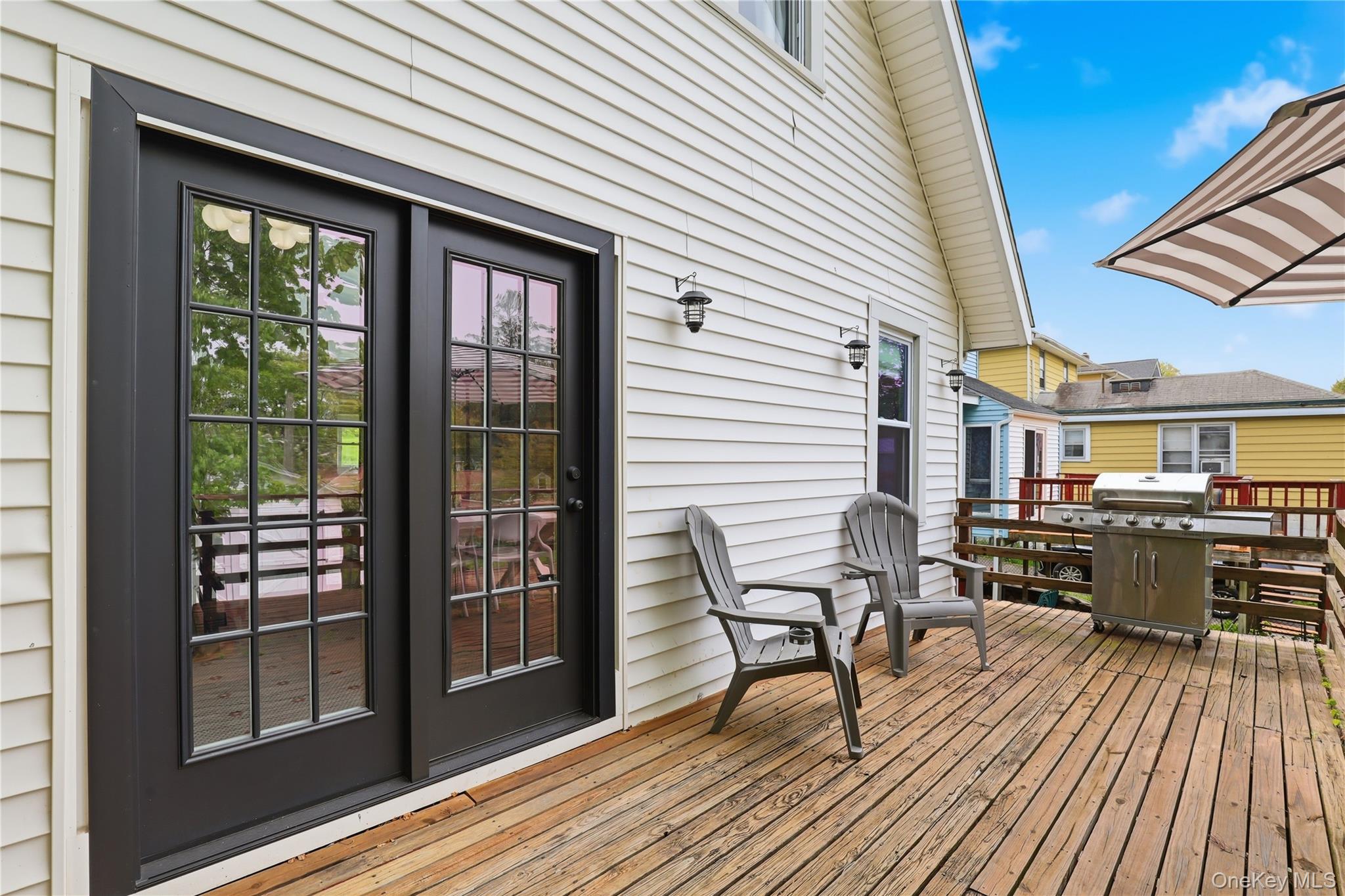 318 Union Avenue Peekskill, NY 10566 - Photo 24 of 30 a view of a patio with table and chairs and wooden floor
