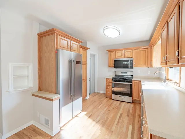 a kitchen with stainless steel appliances granite countertop a stove and a refrigerator
