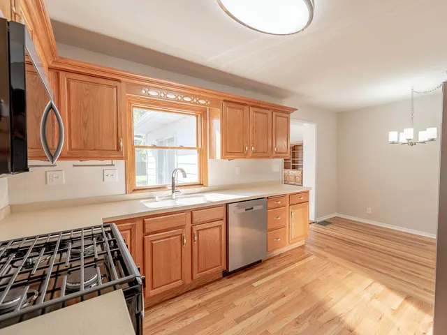 a kitchen with granite countertop a stove and a sink