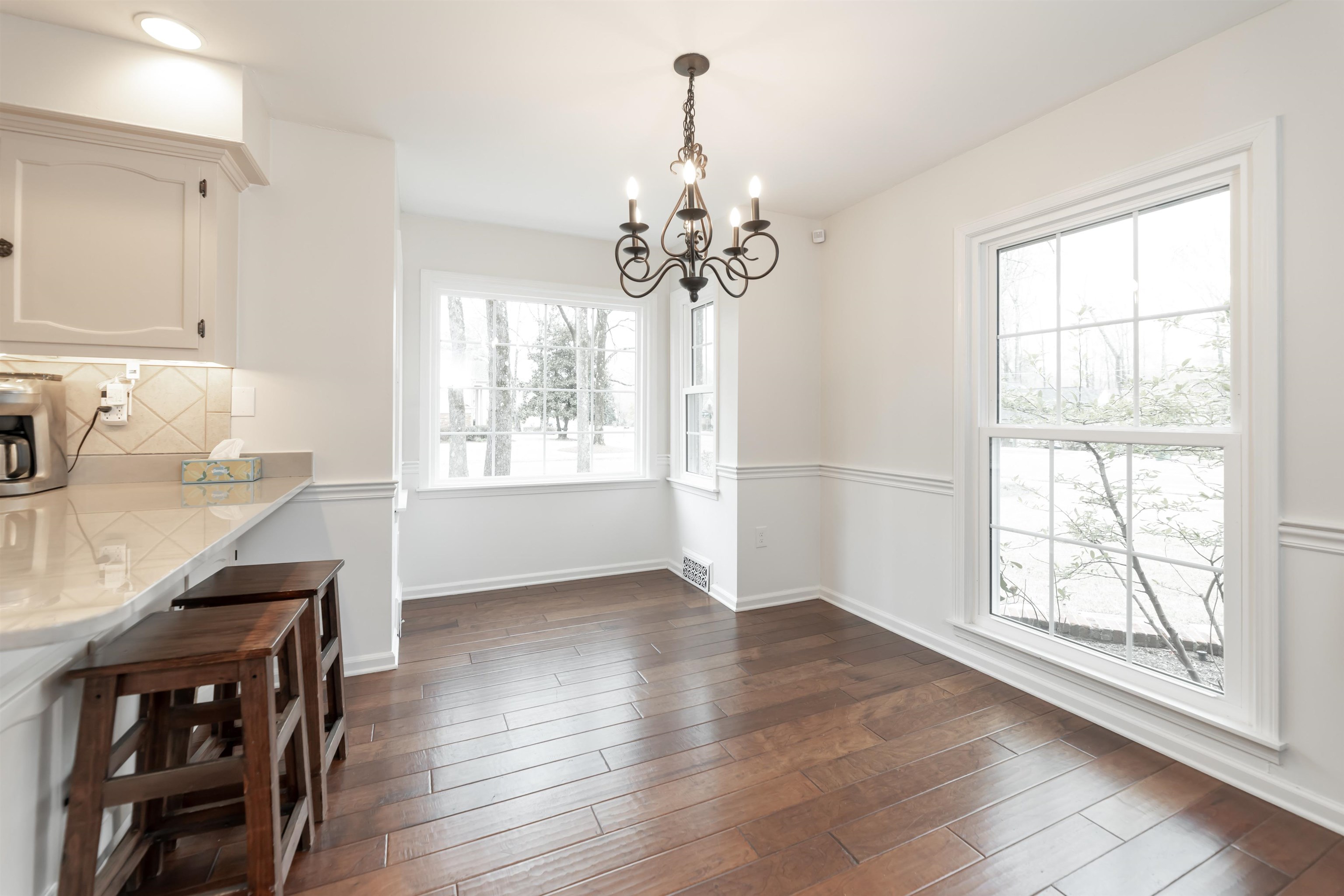 8441 Dogwood Road Germantown, TN 38139 - Photo 11 of 29 Unfurnished dining area with hanging lights and dark wood-style flooring