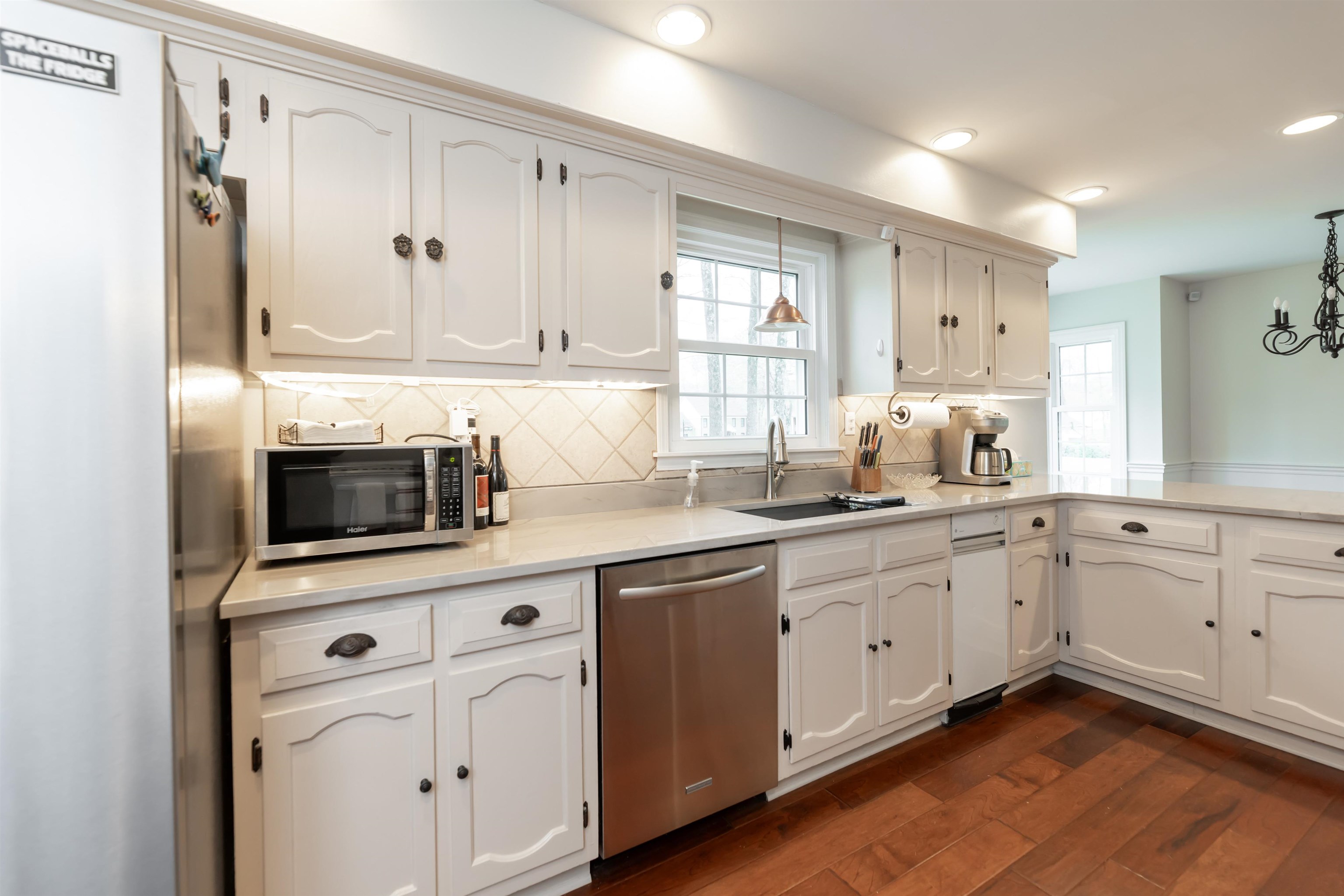 8441 Dogwood Road Germantown, TN 38139 - Photo 13 of 29 Kitchen with stainless steel appliances, white cabinets, dark wood-style floors, and light stone counters