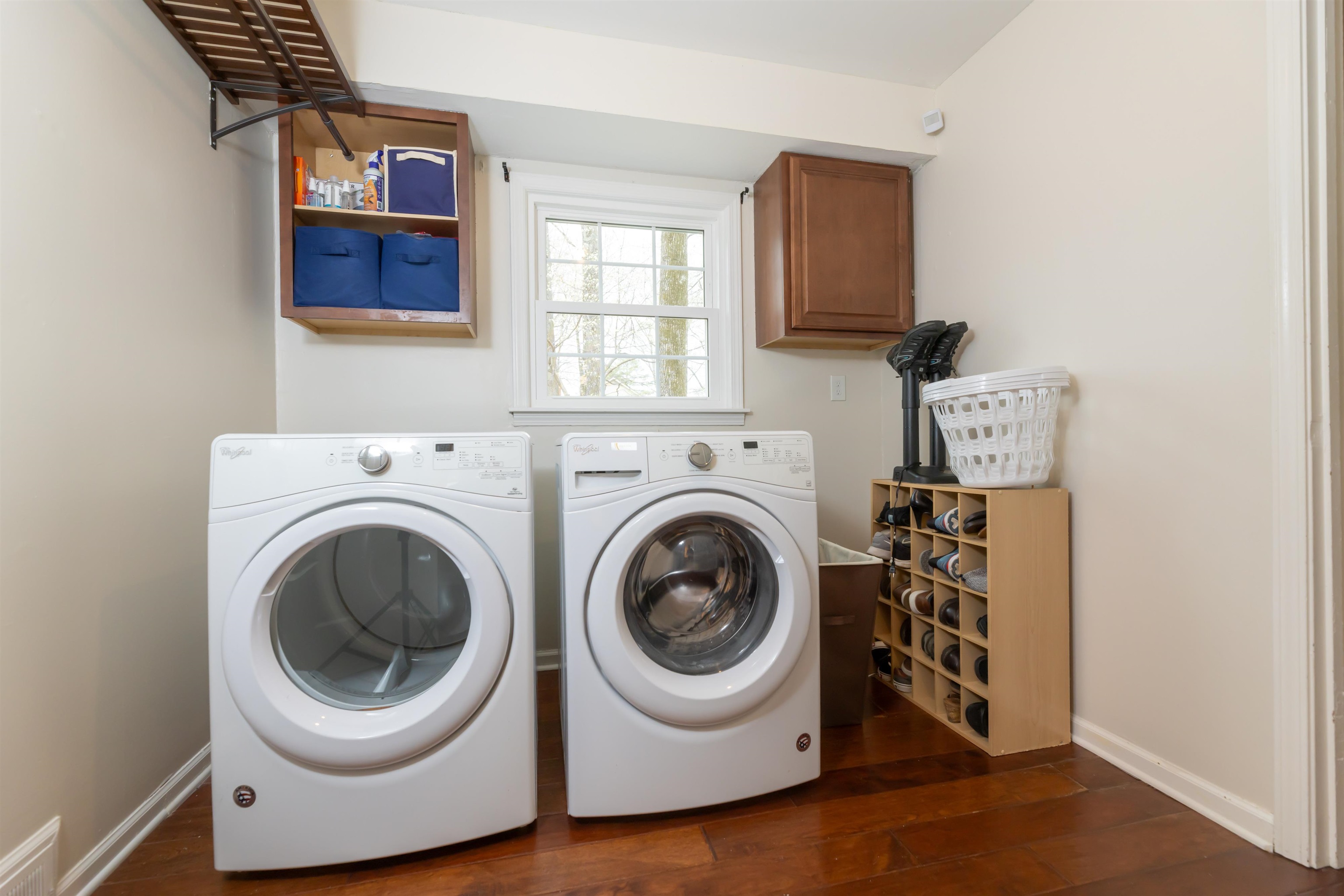 8441 Dogwood Road Germantown, TN 38139 - Photo 15 of 29 Laundry area featuring dark wood-style floors, washing machine and clothes dryer, and cabinet space