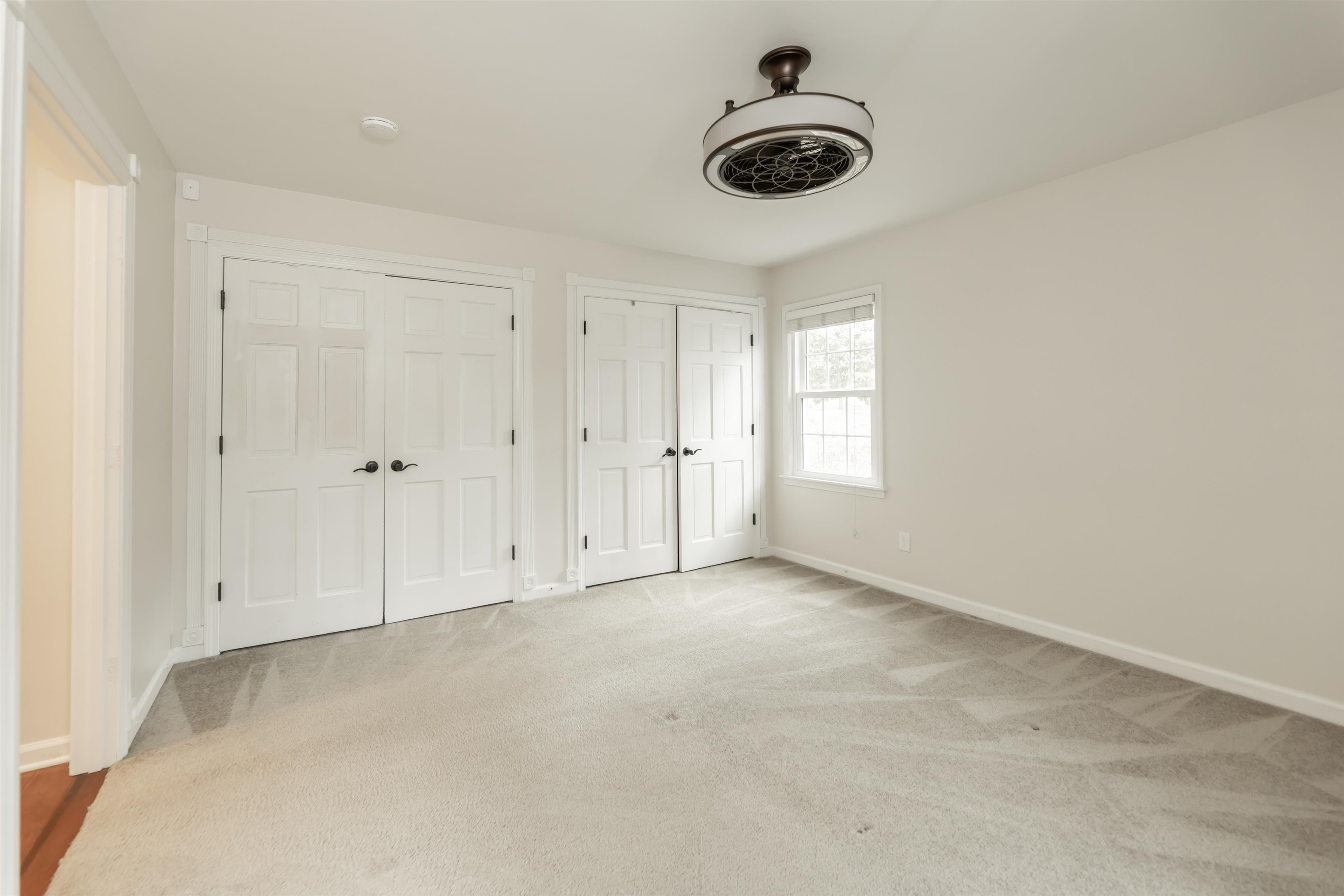 8441 Dogwood Road Germantown, TN 38139 - Photo 16 of 29 Unfurnished bedroom with multiple closets, light carpet, and ceiling fan