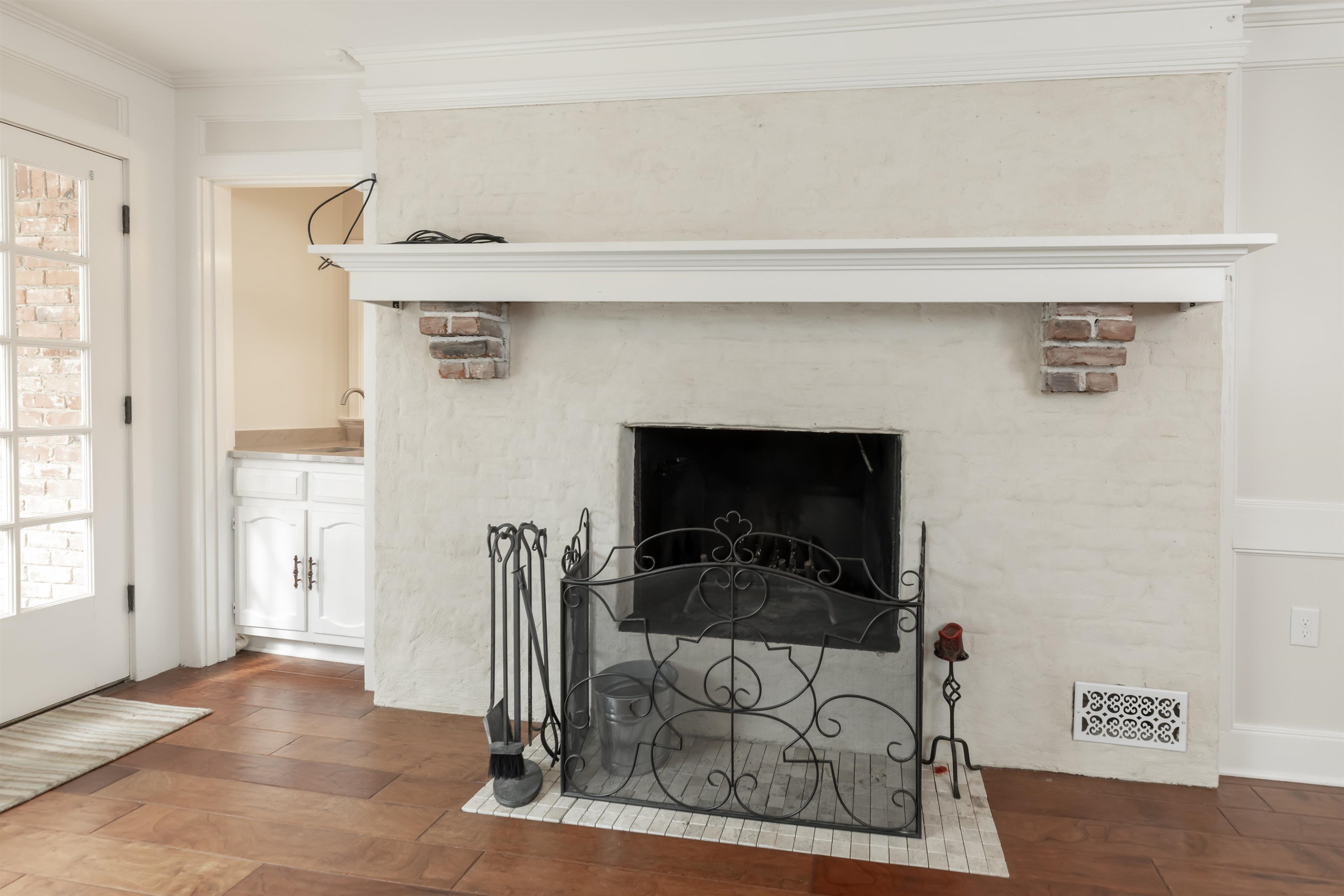 8441 Dogwood Road Germantown, TN 38139 - Photo 10 of 29 Detailed view of ornamental molding, wood finished floors, and a fireplace with flush hearth