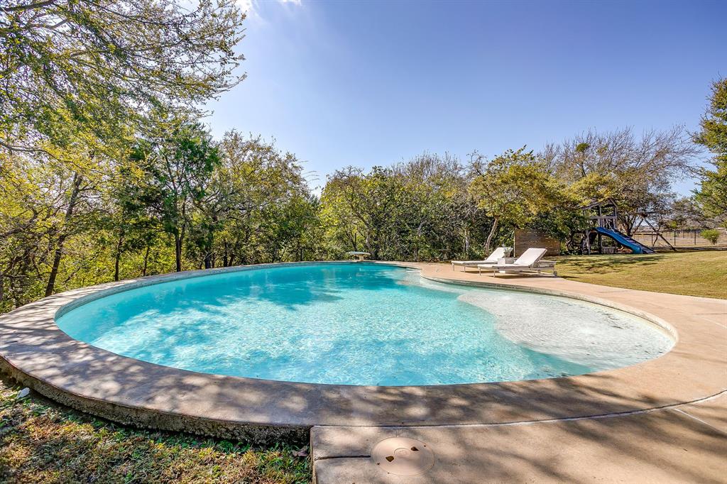 357 Wood Lake Road Aledo, TX 76008 - Photo 11 of 40 a view of a swimming pool with an outdoor space