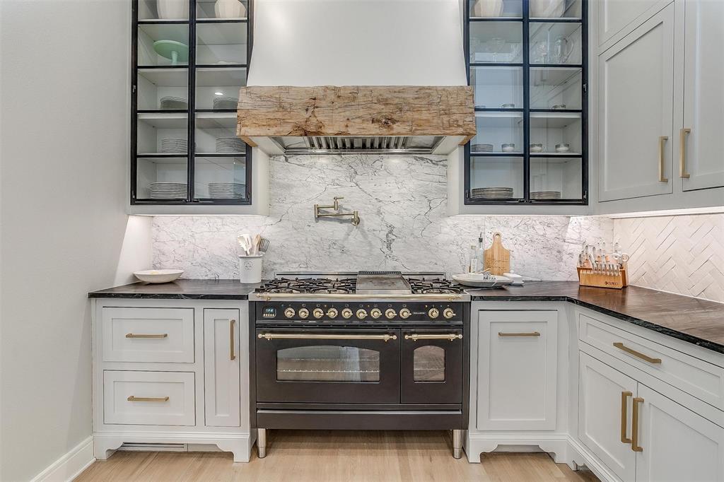 357 Wood Lake Road Aledo, TX 76008 - Photo 18 of 40 a kitchen with granite countertop a stove and a sink