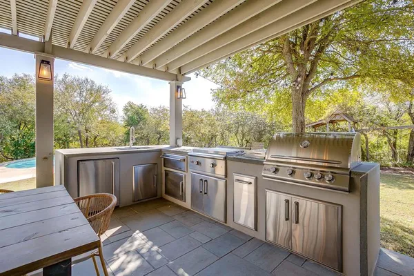 a view of house with swimming pool and outdoor seating