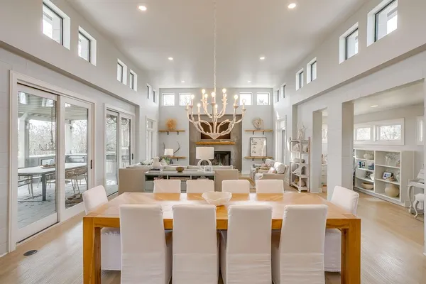 a very nice looking living room with a large window and chandelier