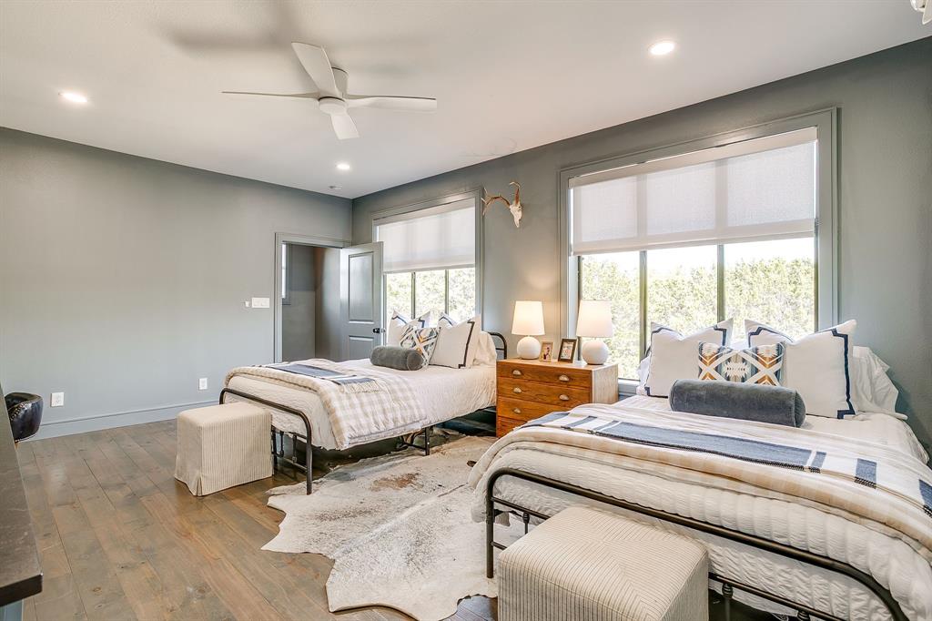 357 Wood Lake Road Aledo, TX 76008 - Photo 32 of 40 a bedroom with a bed and large windows