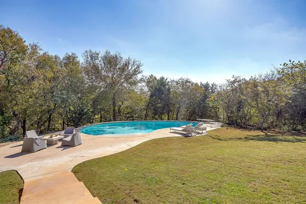 a view of a swimming pool with an outdoor space and seating area