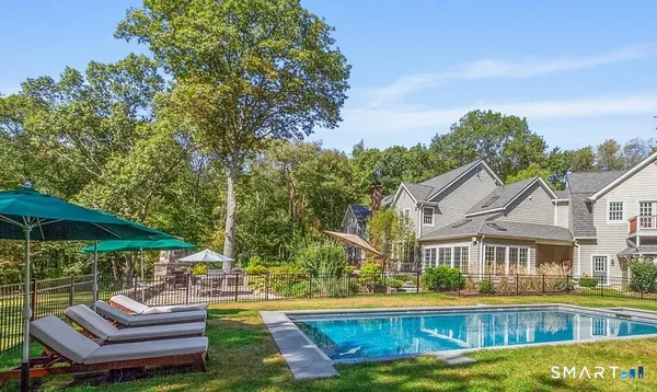 a view of a house with swimming pool and sitting area